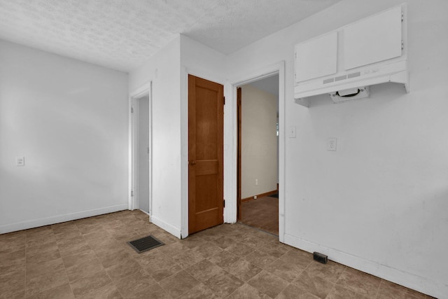 empty room featuring a textured ceiling