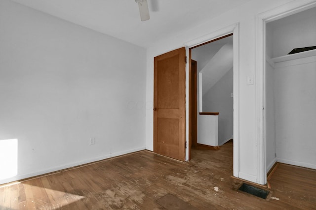 unfurnished bedroom featuring dark hardwood / wood-style flooring and ceiling fan