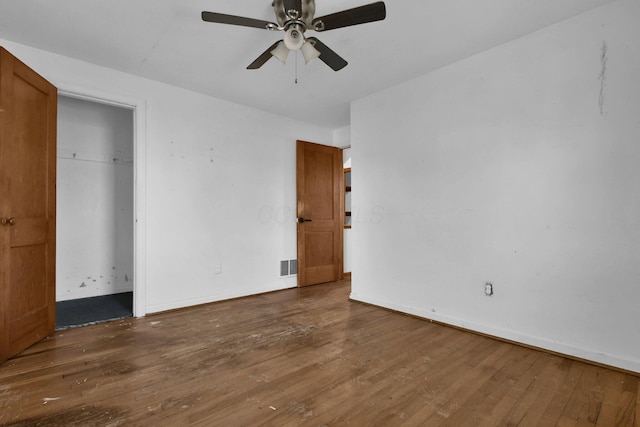 unfurnished bedroom with dark hardwood / wood-style floors and ceiling fan