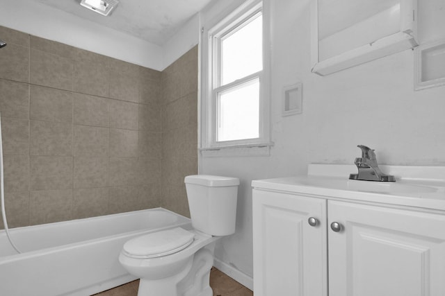 full bathroom featuring vanity, toilet, tiled shower / bath, and a wealth of natural light