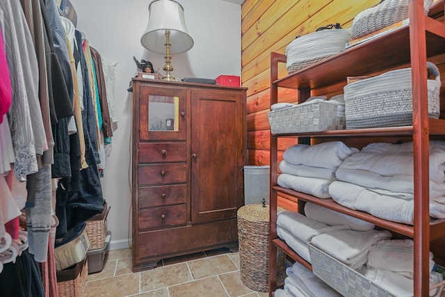 bedroom featuring wooden walls