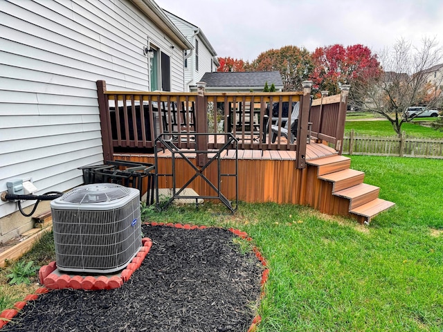 wooden deck featuring a yard and central AC unit