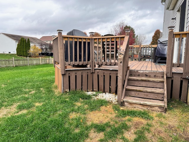 wooden terrace featuring a lawn