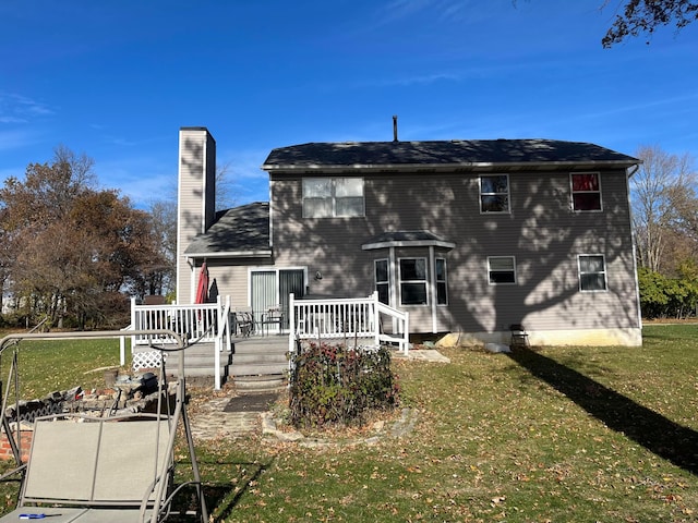 back of property featuring a deck and a yard