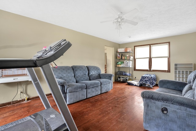 living room featuring ceiling fan and dark hardwood / wood-style floors