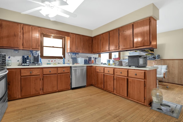 kitchen with stainless steel dishwasher, ceiling fan, light wood-type flooring, and tasteful backsplash