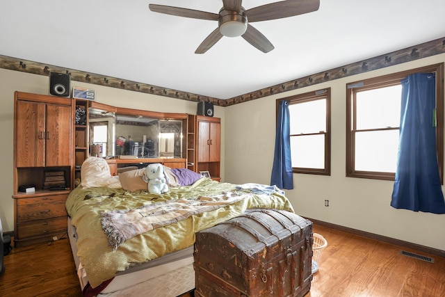 bedroom with hardwood / wood-style floors and ceiling fan