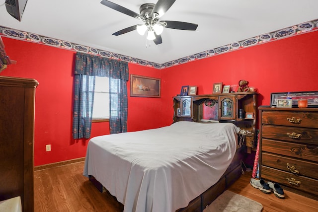 bedroom featuring hardwood / wood-style floors and ceiling fan