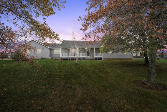 view of front of home with a lawn and a deck