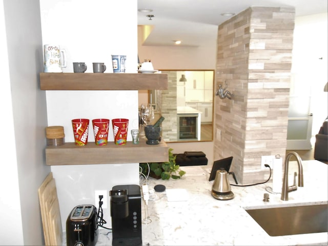 interior space with light stone countertops and sink