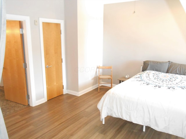 bedroom with wood-type flooring