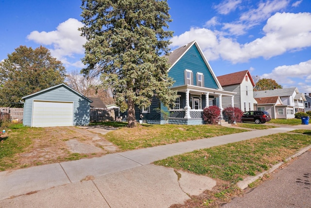 view of front of property featuring a porch, a garage, and a front lawn