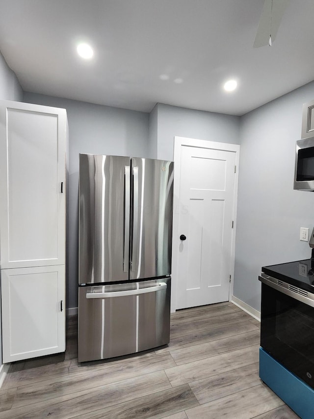 kitchen with recessed lighting, baseboards, appliances with stainless steel finishes, and light wood finished floors