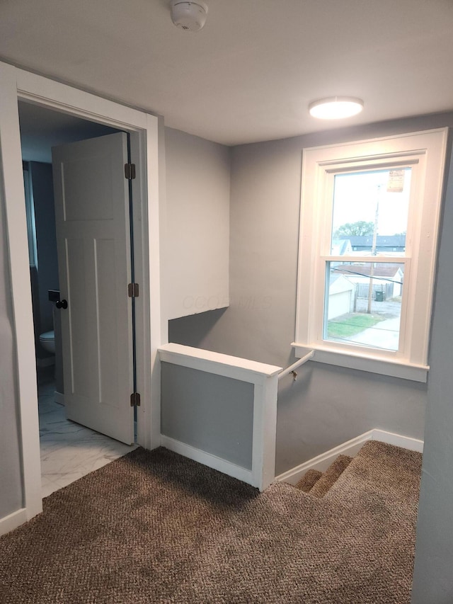 corridor featuring visible vents, marble finish floor, and baseboards