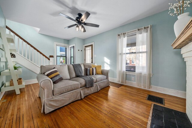 living room with ceiling fan and hardwood / wood-style floors