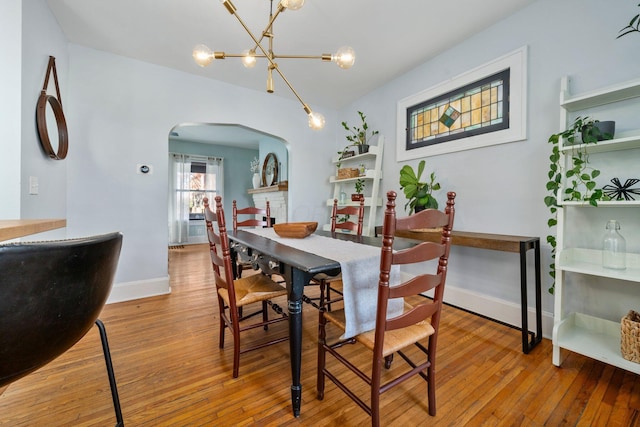 dining area featuring a notable chandelier and hardwood / wood-style flooring