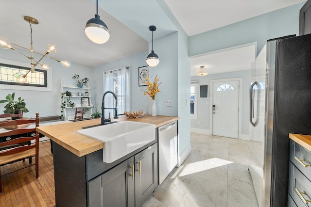 kitchen with butcher block countertops, plenty of natural light, and appliances with stainless steel finishes