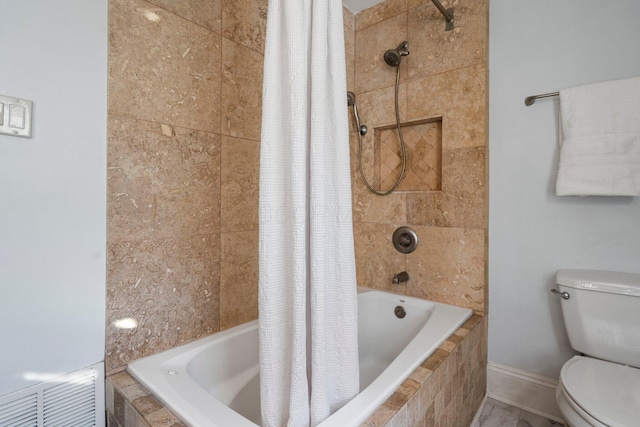 bathroom with shower / bath combo and toilet