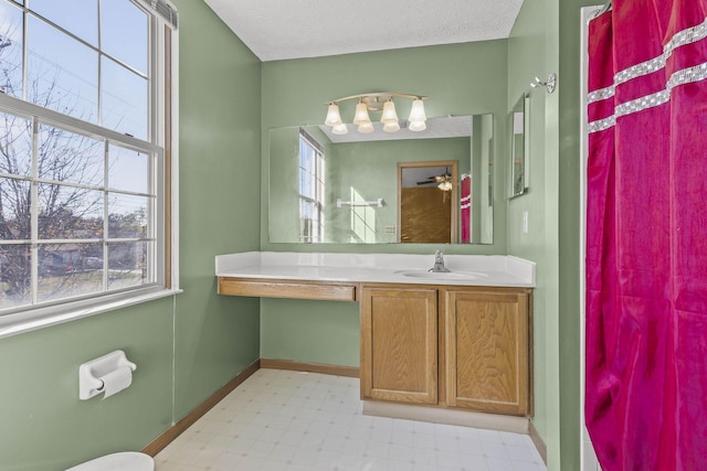 bathroom featuring a textured ceiling and vanity