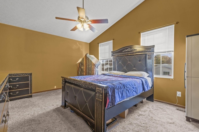 bedroom featuring a textured ceiling, ceiling fan, lofted ceiling, and light carpet