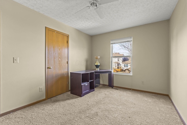 interior space with light carpet, a textured ceiling, and ceiling fan