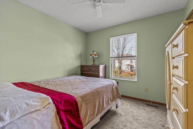 bedroom with light carpet, a textured ceiling, and ceiling fan