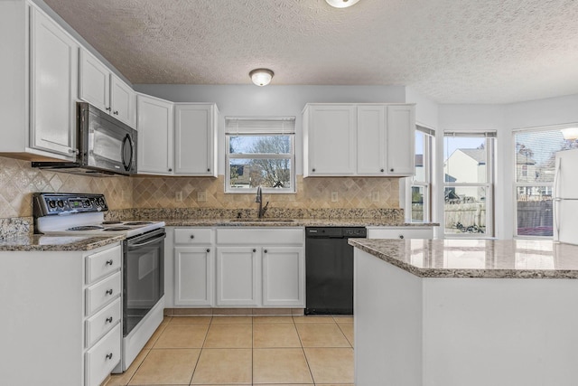 kitchen with sink, white cabinets, black appliances, and plenty of natural light