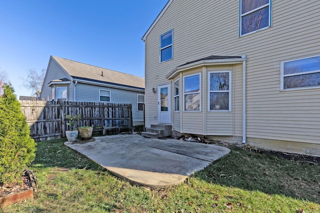 back of house with a yard and a patio