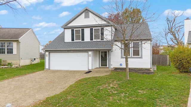 view of front of property featuring a front yard and a garage