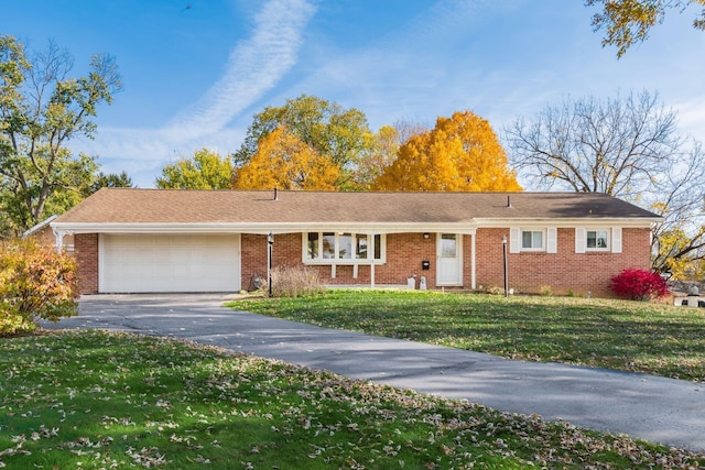 ranch-style home with a front yard and a garage