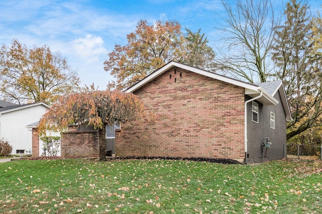 view of side of property with a lawn