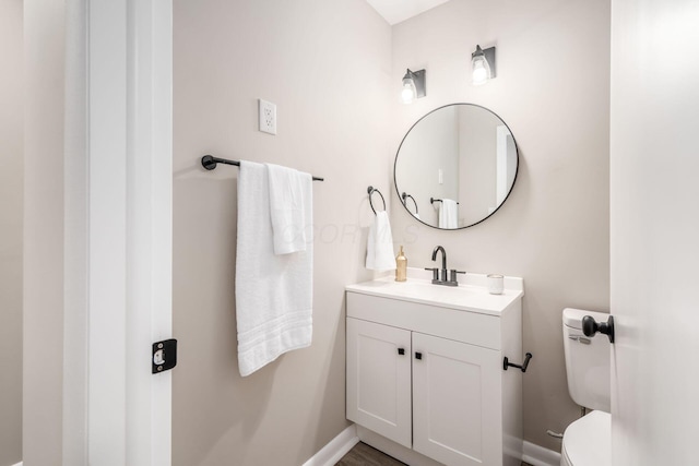 bathroom featuring vanity and toilet