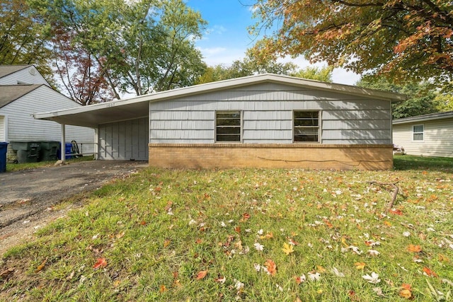 exterior space featuring a carport and a lawn