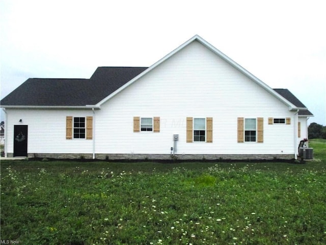 back of property featuring a yard and cooling unit