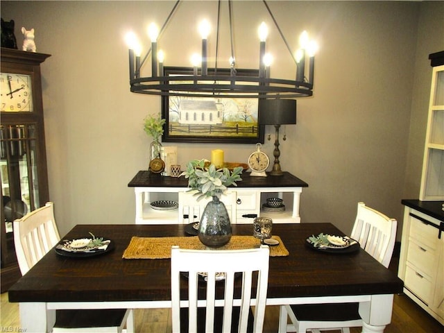 dining room featuring a notable chandelier and dark hardwood / wood-style floors