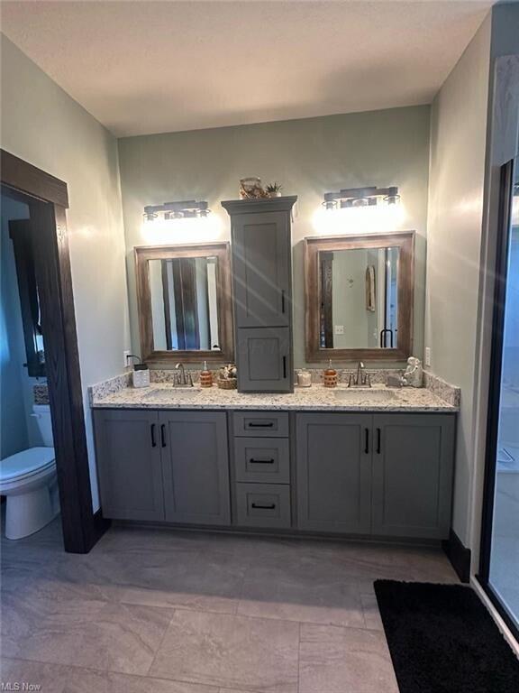 bathroom featuring vanity and toilet