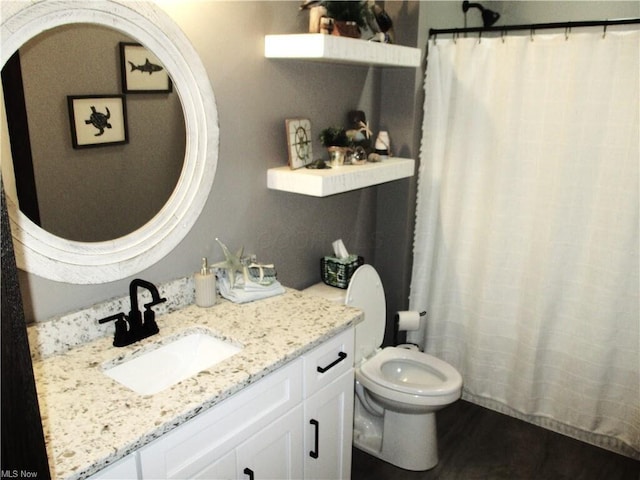 bathroom featuring vanity and toilet