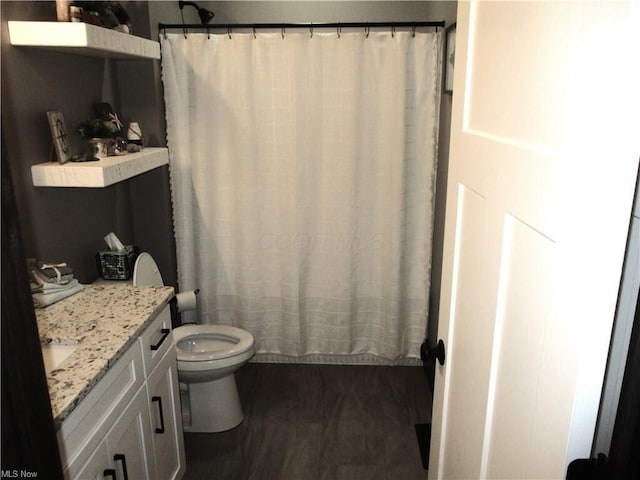 full bathroom featuring shower / bathtub combination with curtain, vanity, wood-type flooring, and toilet