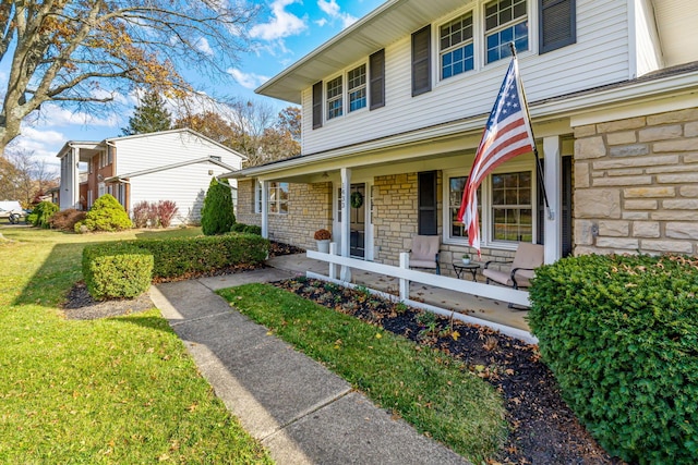 view of front of home with a front yard and a porch