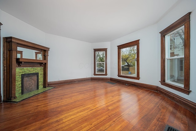 unfurnished living room with wood-type flooring