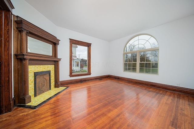 unfurnished living room with hardwood / wood-style flooring