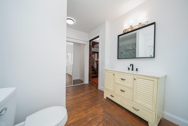 bathroom with vanity, hardwood / wood-style flooring, and toilet