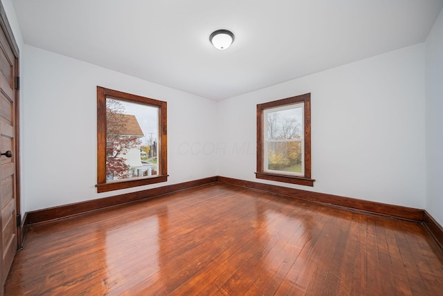 unfurnished room with wood-type flooring