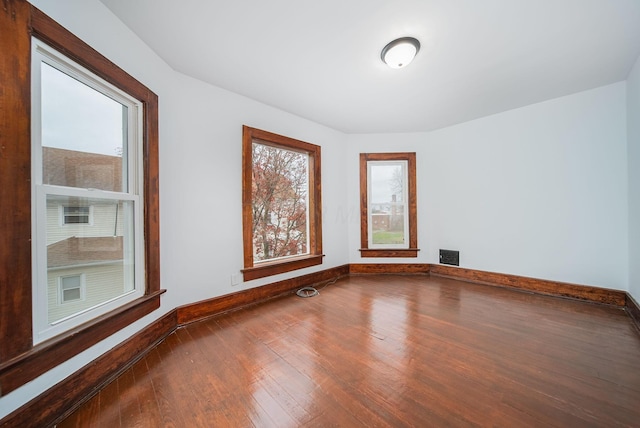 empty room with hardwood / wood-style flooring