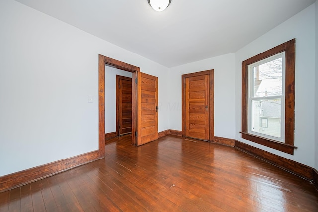 unfurnished bedroom featuring dark hardwood / wood-style flooring