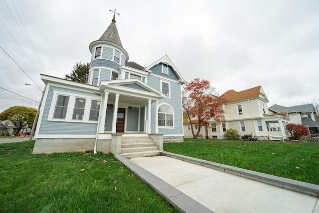 victorian home with a front lawn