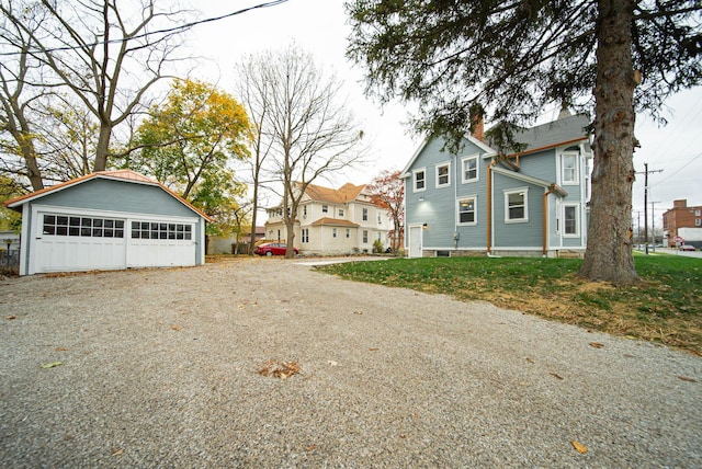 view of home's exterior featuring a garage and an outdoor structure