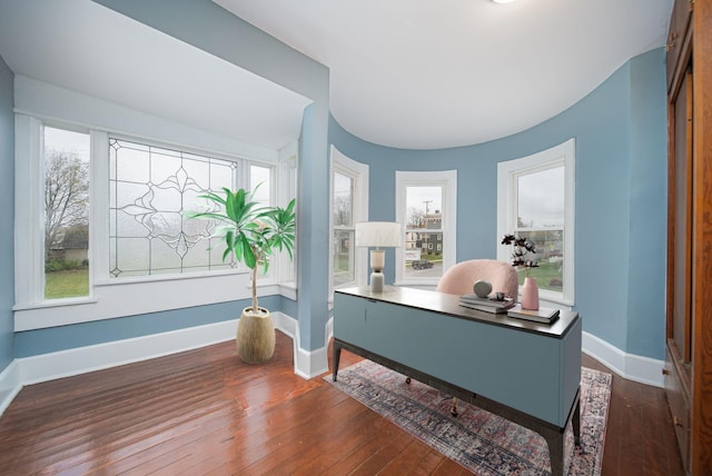 home office with dark hardwood / wood-style floors