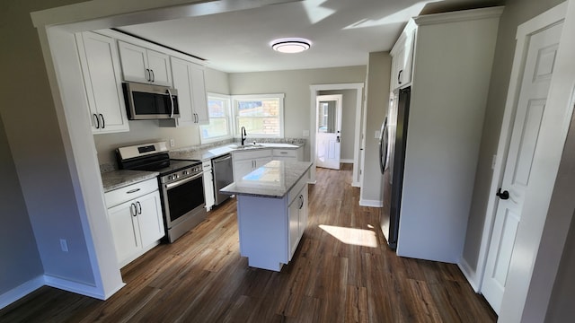 kitchen with appliances with stainless steel finishes, a center island, and white cabinetry