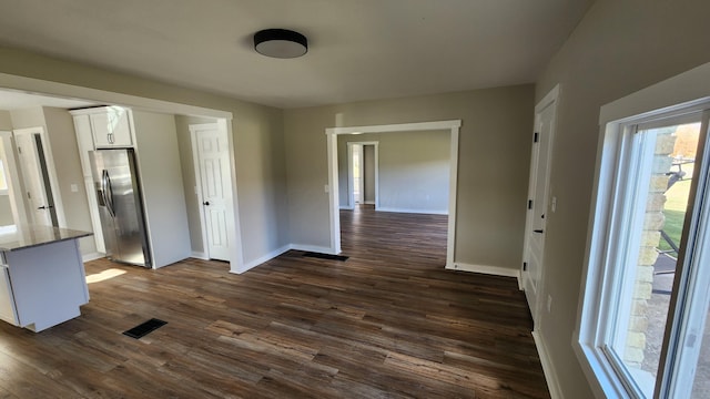 unfurnished dining area featuring dark hardwood / wood-style flooring